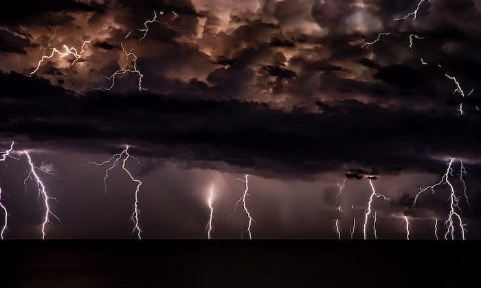 Storm with lightning strikes on a dark horizon.