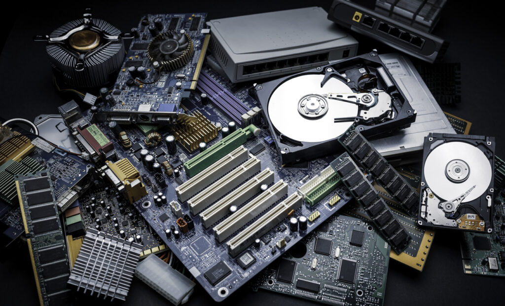 a heap of electronic and computer hardware waste for disposal or recycling - junked computer parts